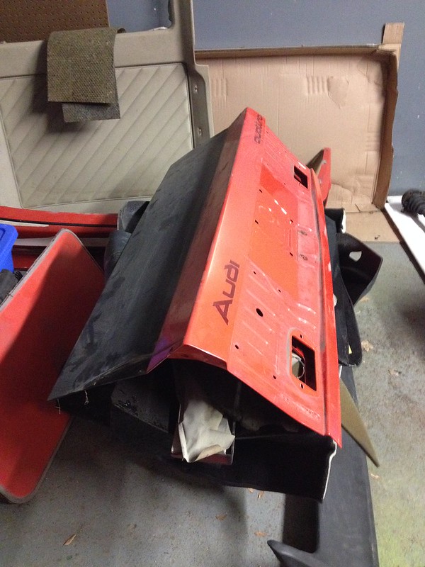 29376111774_3dbb42d7cc_c Red Audi car trunk lid placed upside down in a garage with other car parts around