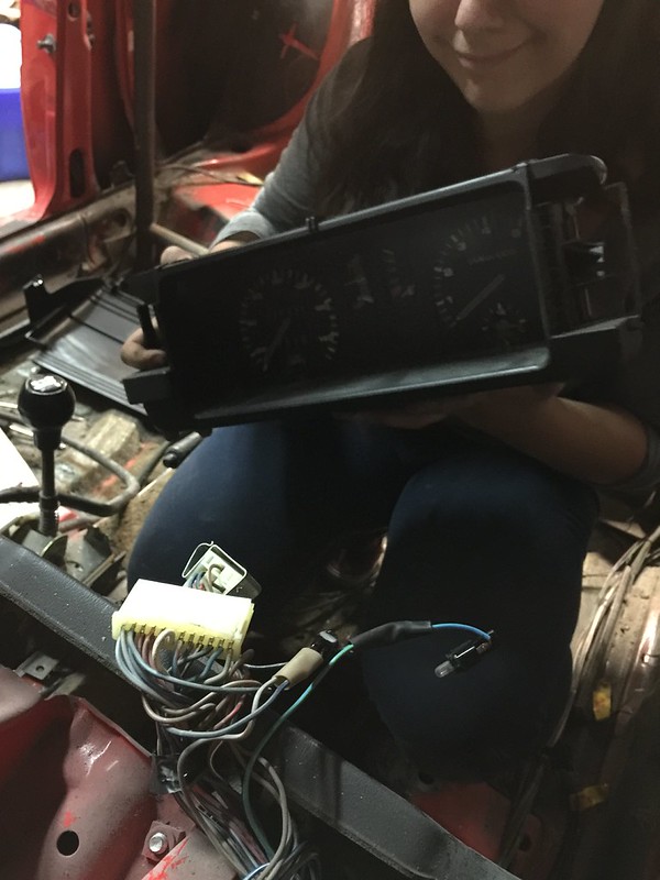 29587218762_31bee3f4ae_c Person holding a car dashboard instrument cluster with exposed wiring inside a vehicle