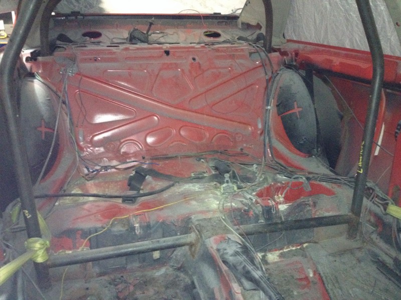 29594504801_282a70c5e7_c Interior of a stripped-down vehicle showing exposed metal framework and wiring