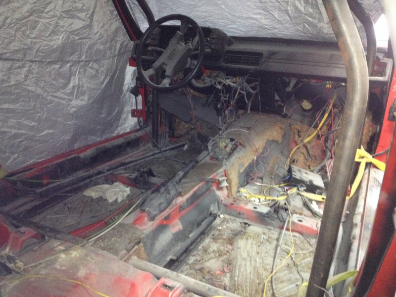 29594504981_b74456e005_c Interior of a stripped-down vehicle with exposed wiring and no seats
