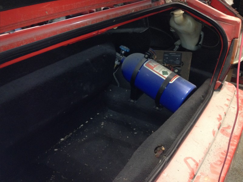 29594505141_b712b546ed_c Blue nitrous oxide bottle secured inside the trunk of a red car