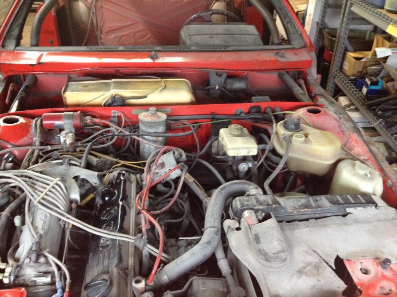 29594505551_425010c65f_c Open engine compartment of an older red car showing engine components and wiring