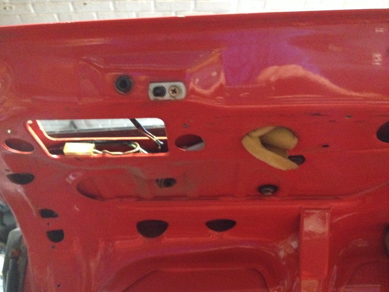 29810724286_e0c9708dd0_c Interior view of a red car door panel with exposed wiring and openings