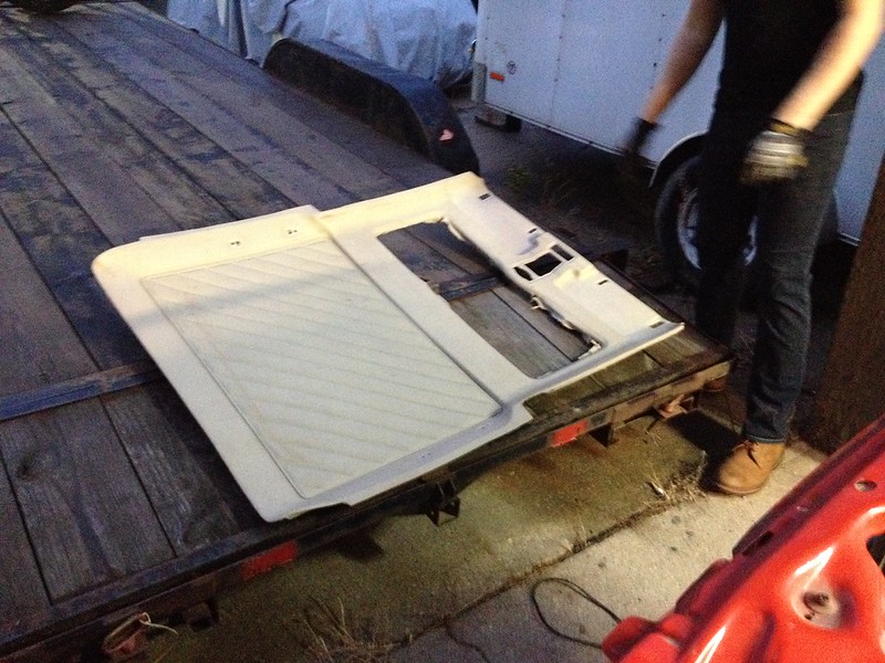30003775115_e834d4c548_c Person wearing gloves standing next to a detached car door laying flat on a trailer
