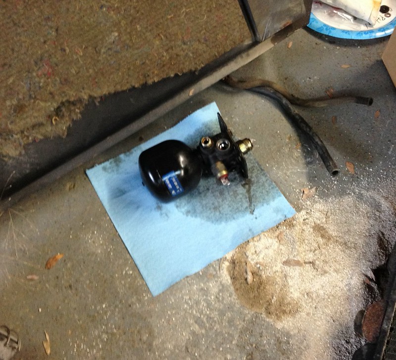 30161304710_3ca4584979_c Black automotive or mechanical part resting on a blue shop towel on a concrete floor with nearby stains and debris