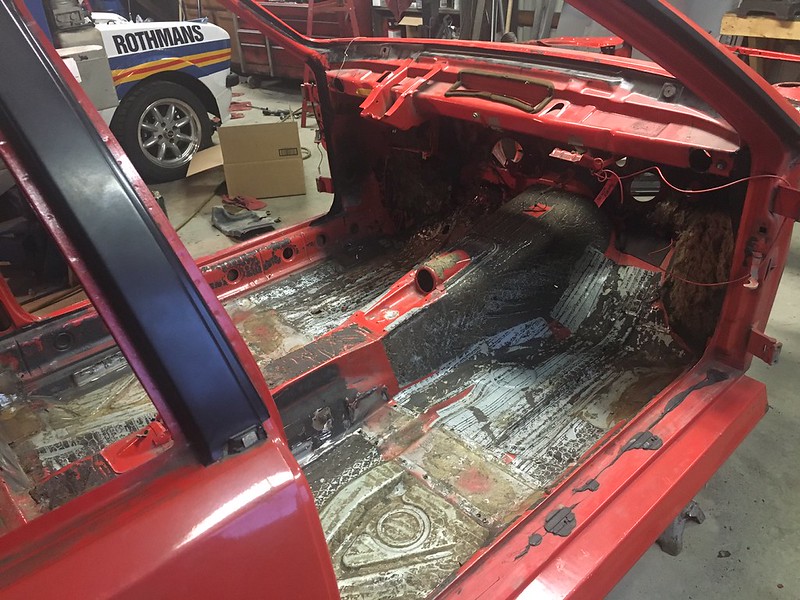 30855370253_64dcb072f6_c Interior of a red car stripped down to bare metal, showing the floor and transmission tunnel in a workshop