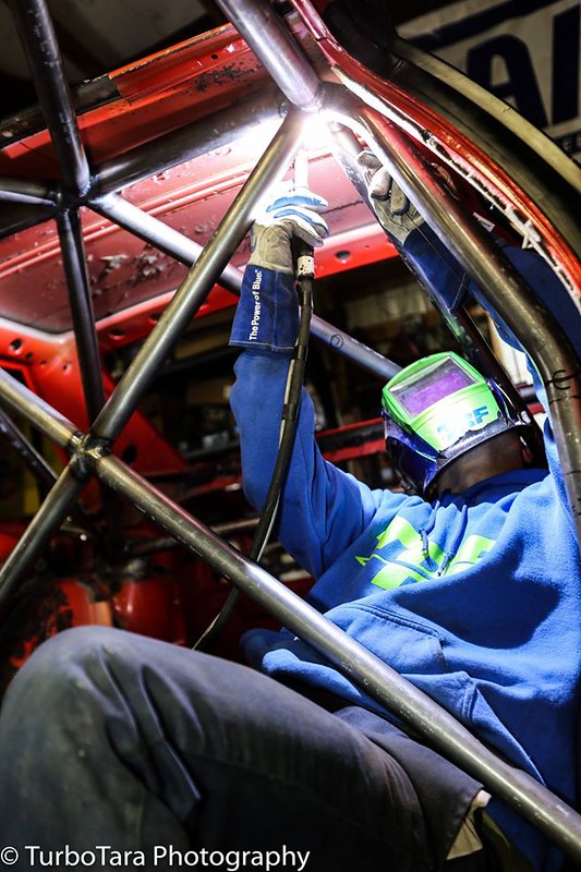 31318106363_9c9b1f7537_c Person wearing welding helmet and gloves welding metal frame inside a UR Quattro