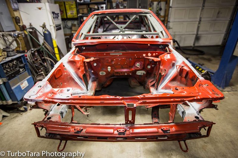 Empty UR Quattro chassis inside a garage with tools and equipment around
