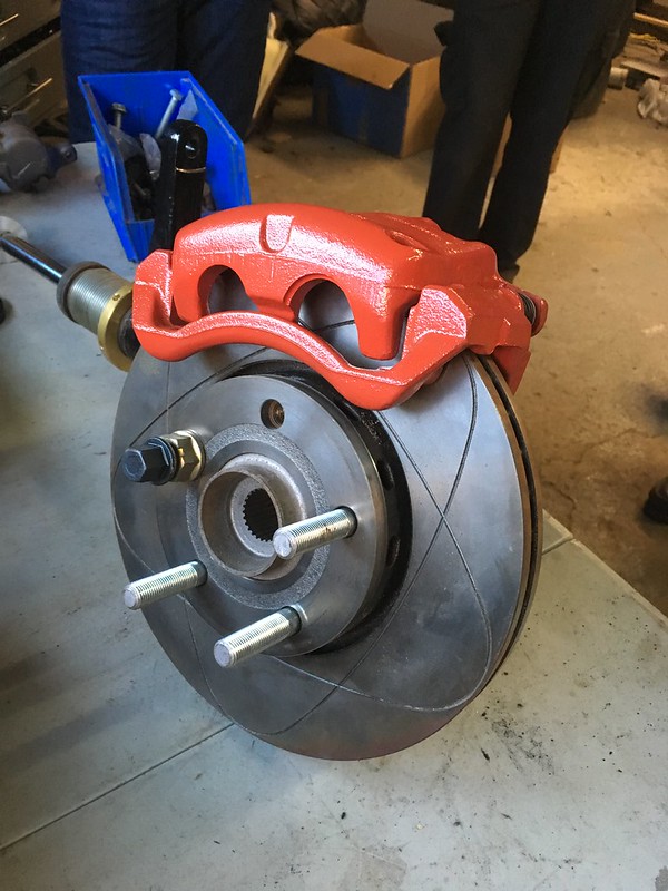 32066332964_4a5e489eaf_c UR Quattro red brake caliper mounted on a ventilated and slotted brake disc