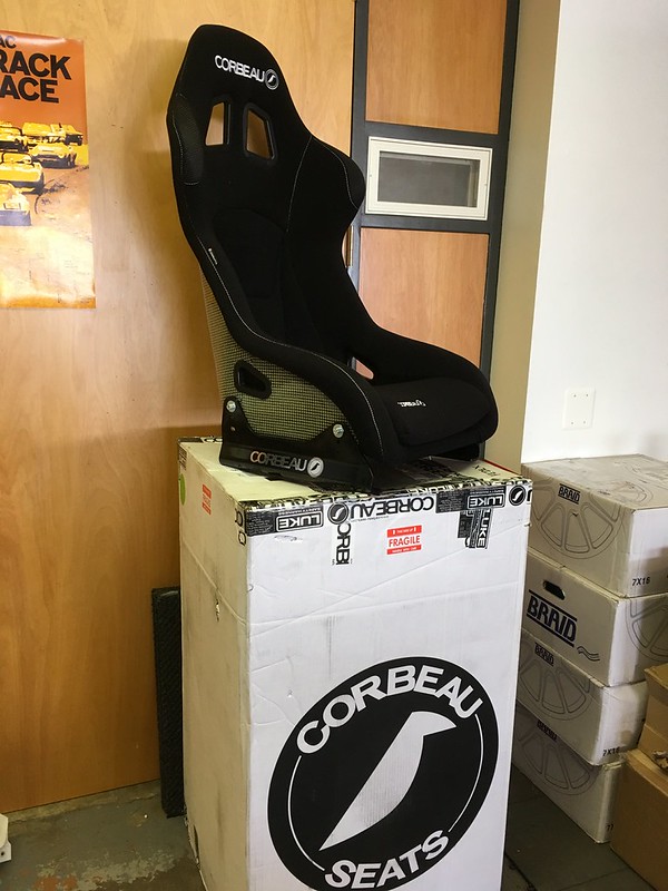32786834772_6c1880d883_c Black Corbeau racing seat placed on top of large Corbeau Seats box in storage area