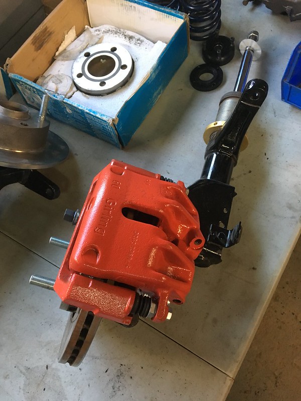 32868608926_093eedcdd8_c Red-painted UR Quattro brake caliper attached to a brake rotor and black suspension strut on a workshop table
