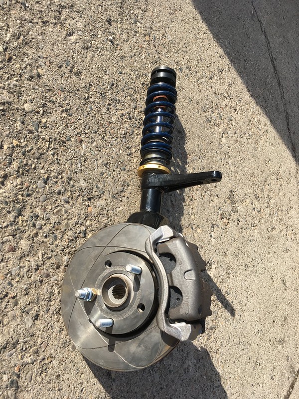 UR Quattro suspension strut with brake rotor and caliper assembly on concrete floor