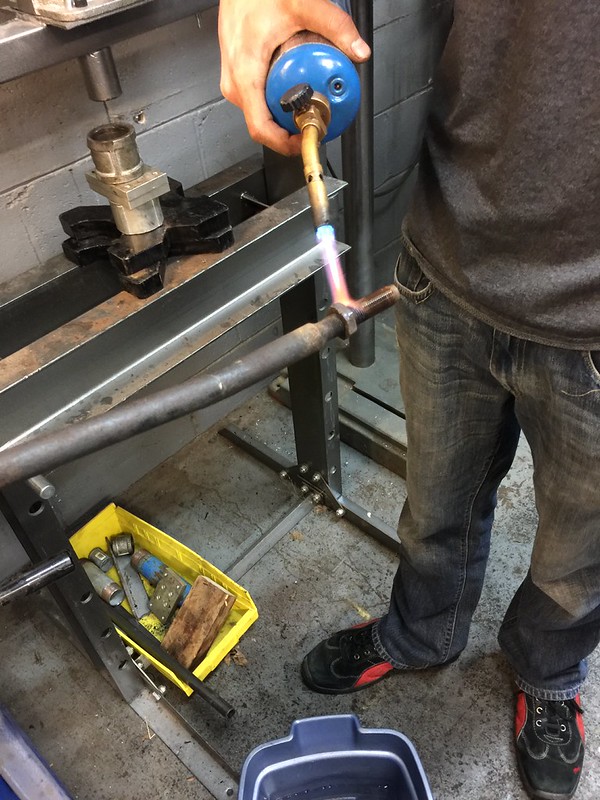 33971031656_5253b74023_c Person using a blue torch to heat a UR Quattro suspension component in a workshop