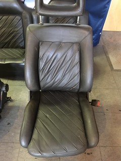 A black leather UR Quattro seat with a diamond-stitched pattern, viewed from the front.