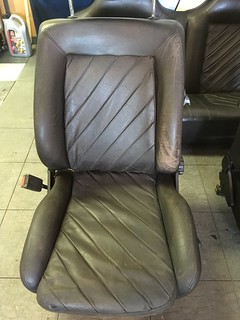 A worn brown leather UR Quattro seat with a diamond pattern, showing signs of aging and use.