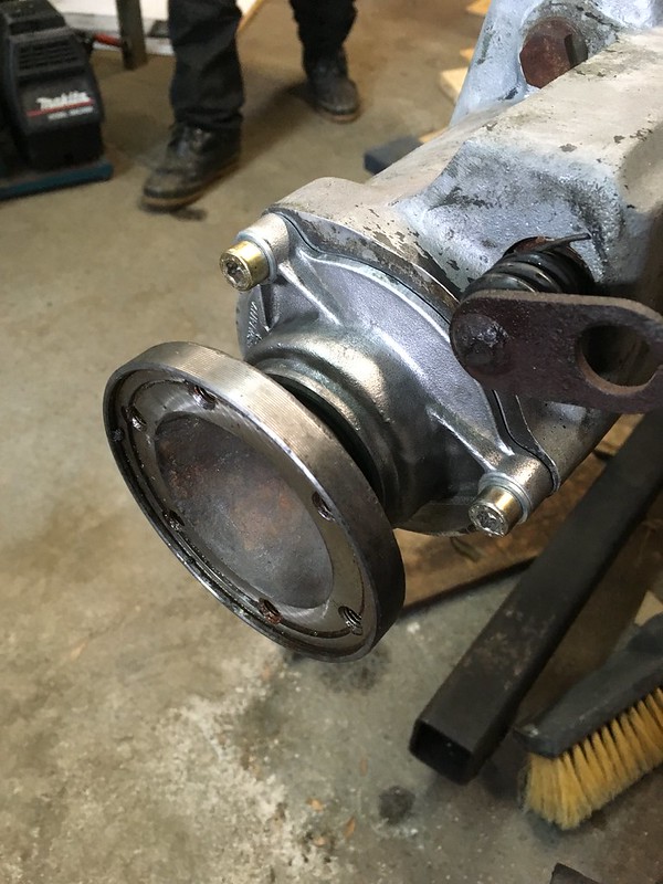 Close-up view of a metallic UR Quattro component, likely a turbocharger, showing the flange and seal details, sitting on a workshop surface.